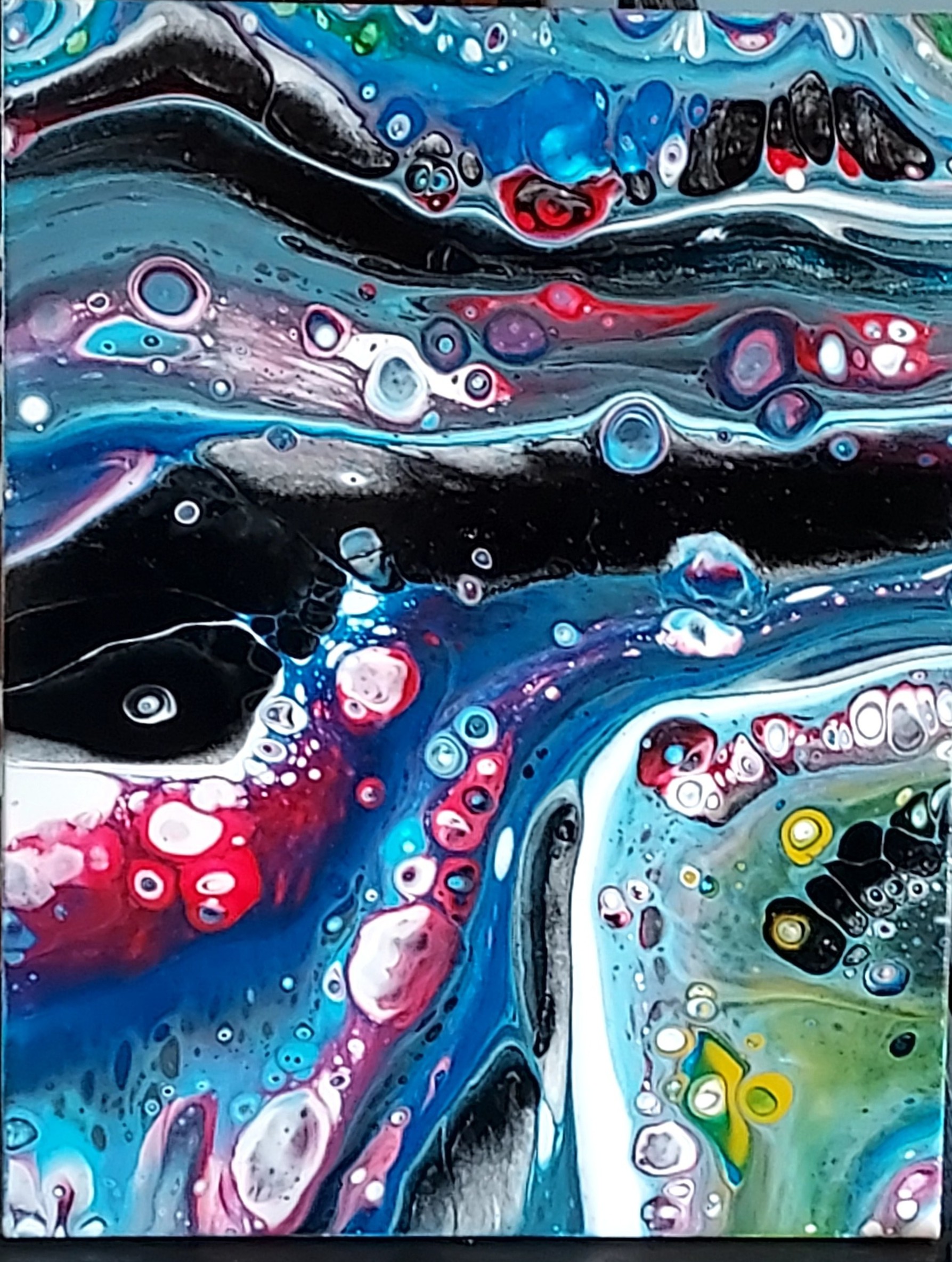 An acrylic fluid art painting in red, white, and blue